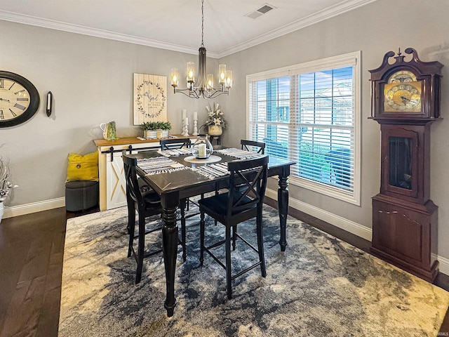 dining area featuring wood finished floors, baseboards, visible vents, ornamental molding, and a chandelier