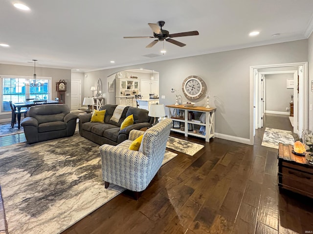 living area with ornamental molding, hardwood / wood-style flooring, recessed lighting, arched walkways, and baseboards