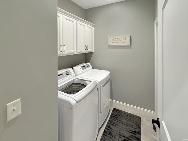 clothes washing area featuring baseboards, cabinet space, independent washer and dryer, and light tile patterned flooring