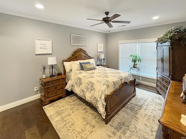 bedroom featuring baseboards, wood finished floors, and ornamental molding