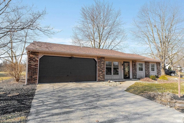 view of front of property featuring brick siding, an attached garage, driveway, and roof with shingles