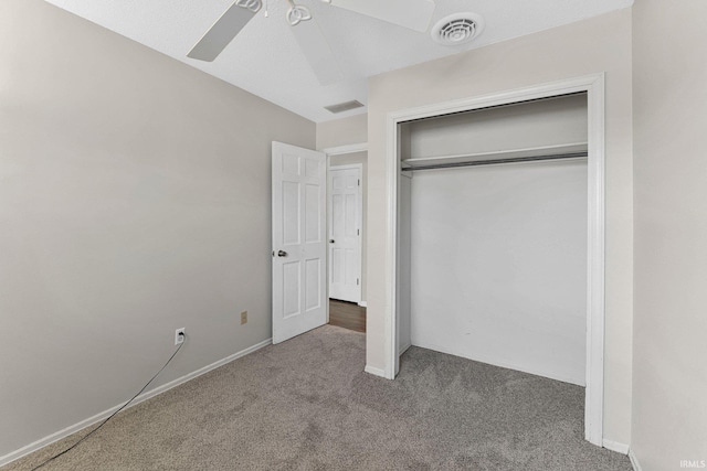 unfurnished bedroom with a closet, visible vents, a ceiling fan, and carpet floors