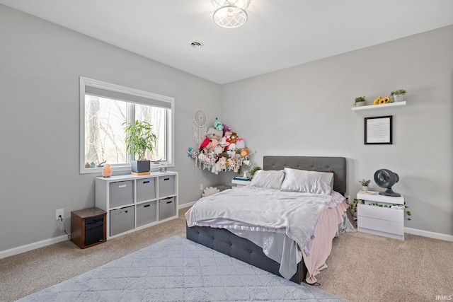 carpeted bedroom featuring visible vents and baseboards