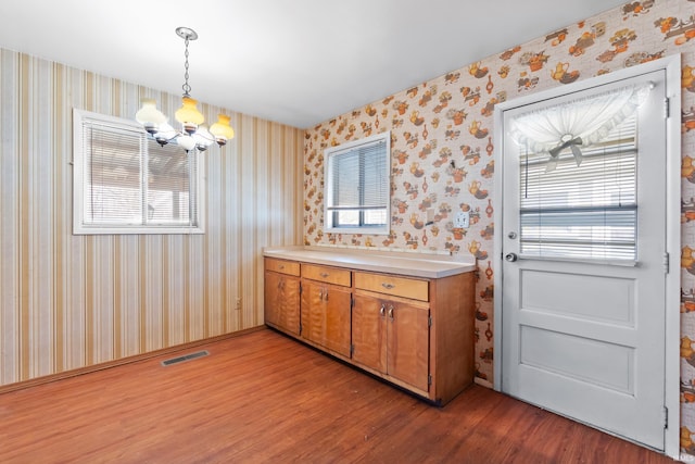 bathroom featuring visible vents, wood finished floors, and wallpapered walls