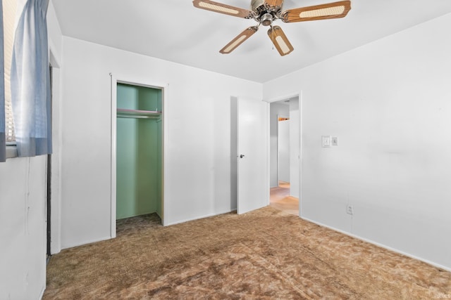 unfurnished bedroom with a closet, carpet, and a ceiling fan