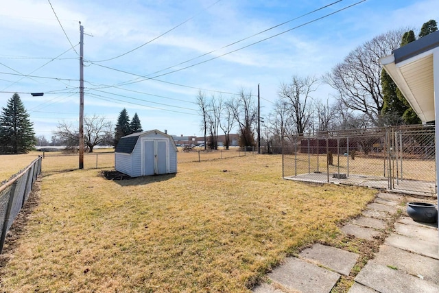 view of yard featuring an outbuilding, a storage unit, and a fenced backyard