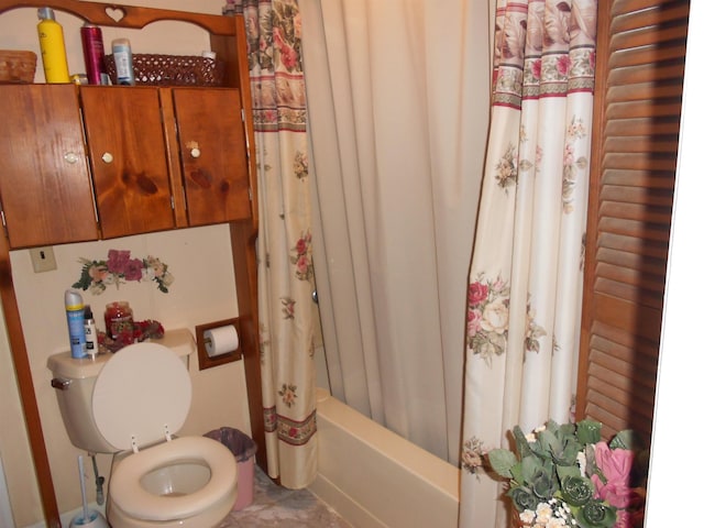 bathroom with toilet and shower / tub combo with curtain