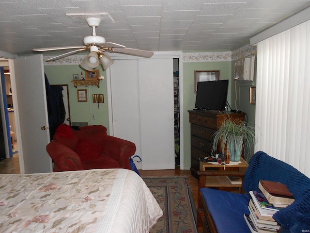 bedroom featuring wood finished floors, a closet, and ceiling fan