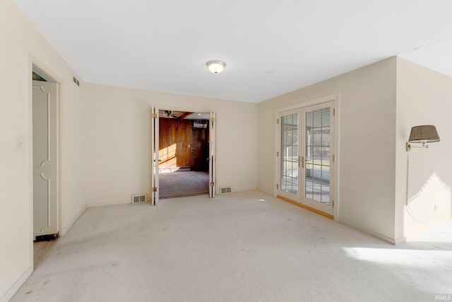 carpeted spare room featuring visible vents