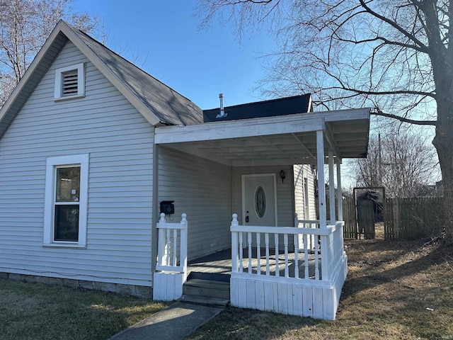 view of front of property featuring fence and covered porch