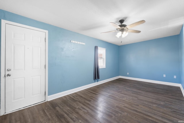 unfurnished room with a ceiling fan, wood finished floors, and baseboards