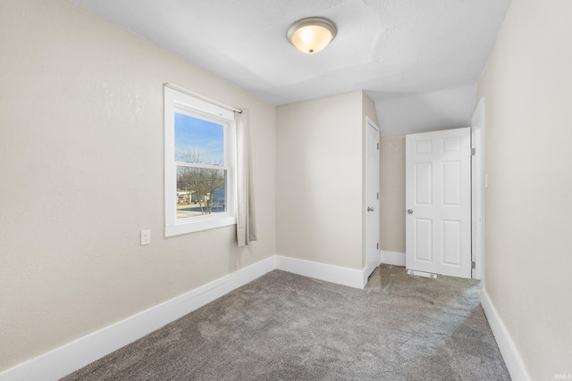 carpeted empty room with baseboards