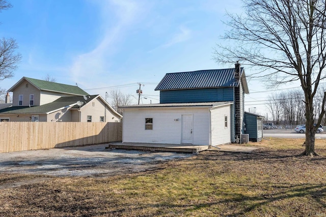 view of outbuilding featuring fence