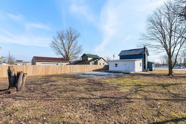 view of yard featuring an outbuilding and fence