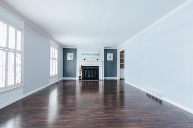 unfurnished living room featuring wood finished floors, visible vents, baseboards, a fireplace, and crown molding