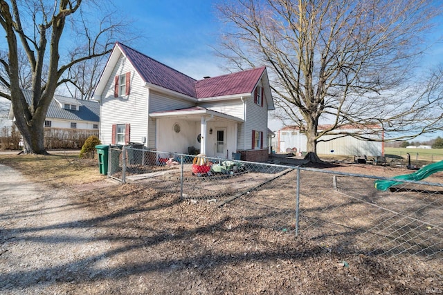 view of side of property featuring a fenced front yard and brick siding