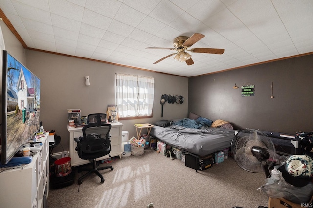 bedroom featuring carpet floors, ornamental molding, and a ceiling fan