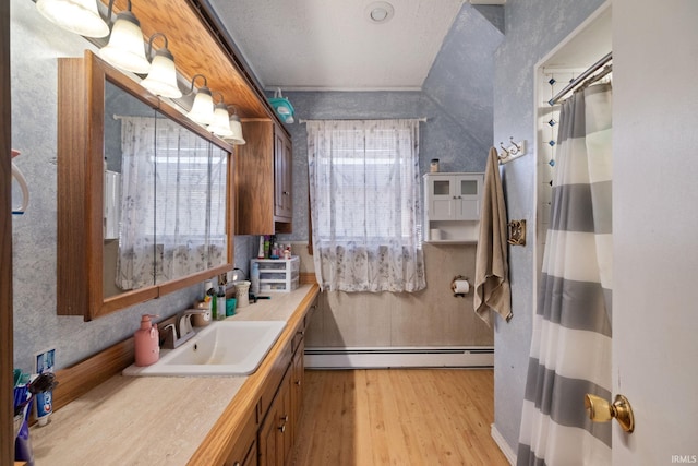 full bath featuring baseboard heating, curtained shower, vanity, and wood finished floors