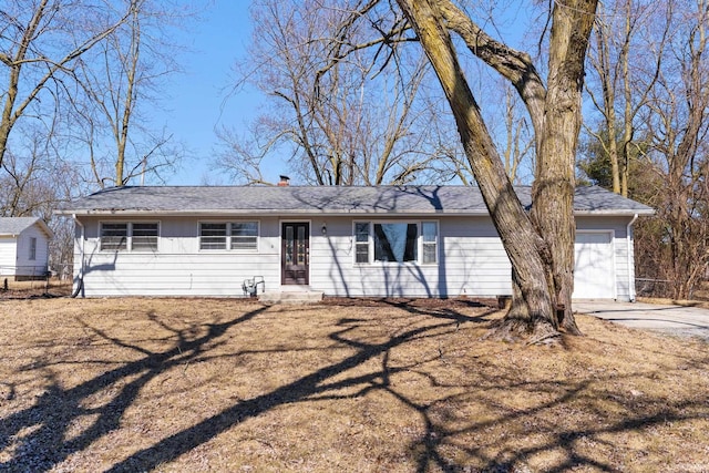 ranch-style house with an attached garage, french doors, and driveway