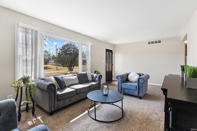 carpeted living area with visible vents and baseboards