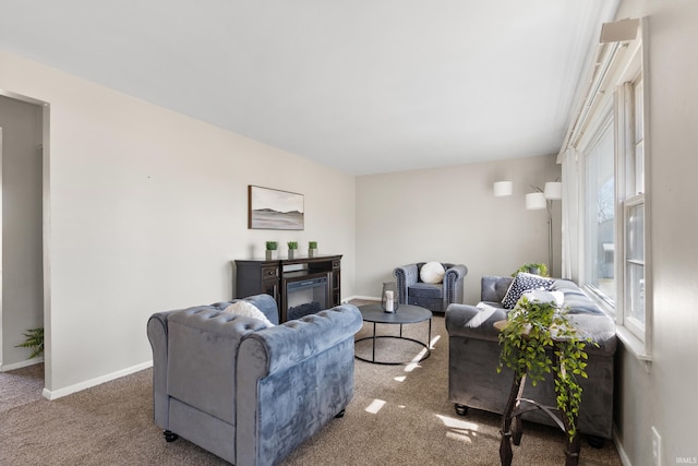 living area with carpet flooring, baseboards, and a fireplace