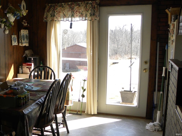 dining room featuring wooden walls