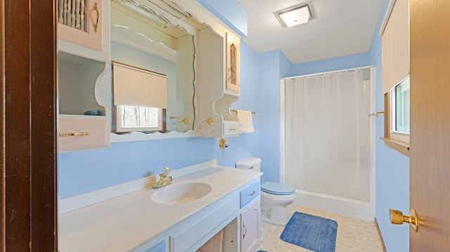 full bathroom with toilet, a stall shower, and vanity