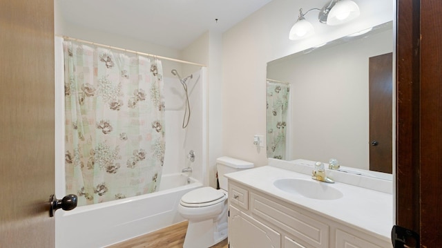 full bathroom featuring vanity, toilet, wood finished floors, and shower / tub combo with curtain