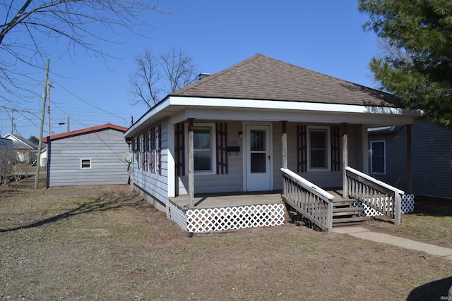 view of front of house featuring roof with shingles and covered porch