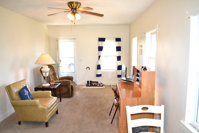 interior space featuring a ceiling fan, carpet, and baseboards