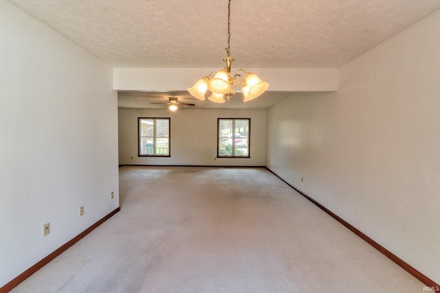 spare room with light carpet, a textured ceiling, baseboards, and an inviting chandelier