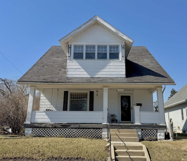 view of front facade with a porch and a shingled roof