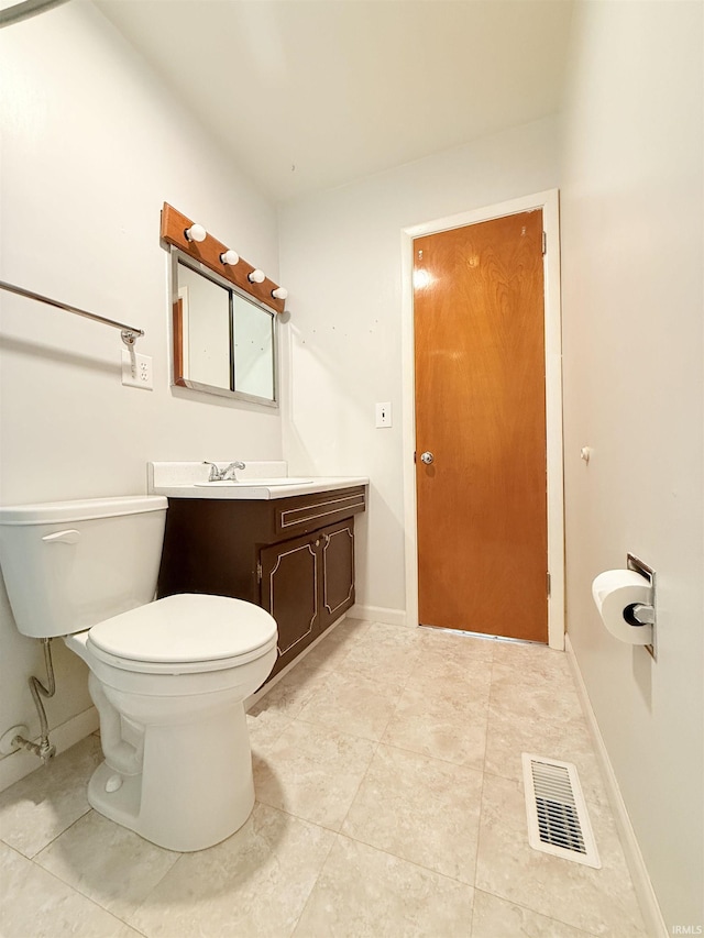 bathroom featuring visible vents, toilet, vanity, and baseboards