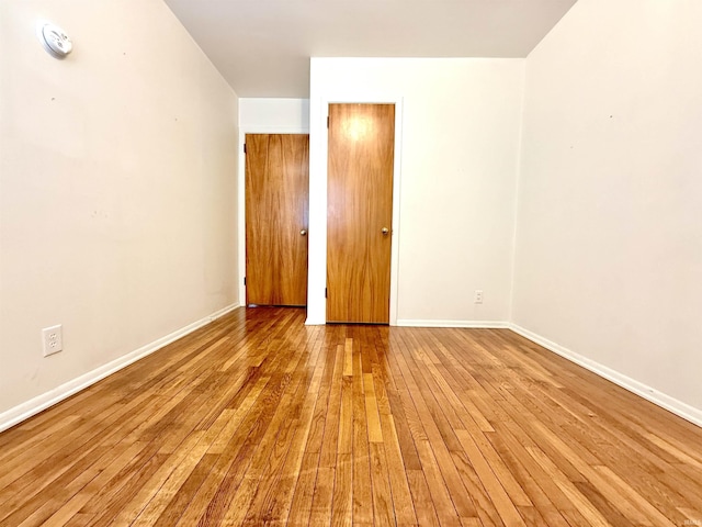 interior space with baseboards and hardwood / wood-style flooring