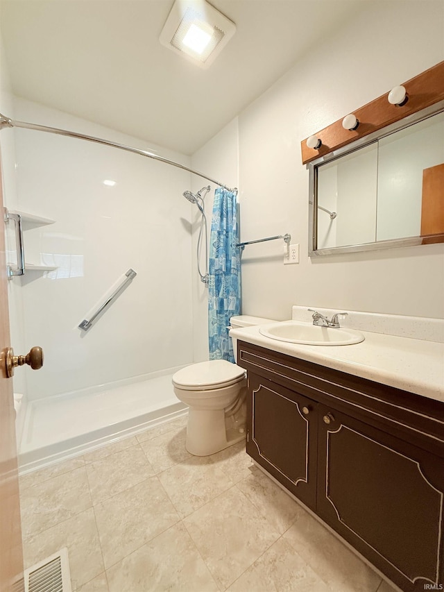 bathroom featuring visible vents, toilet, a shower with shower curtain, tile patterned flooring, and vanity