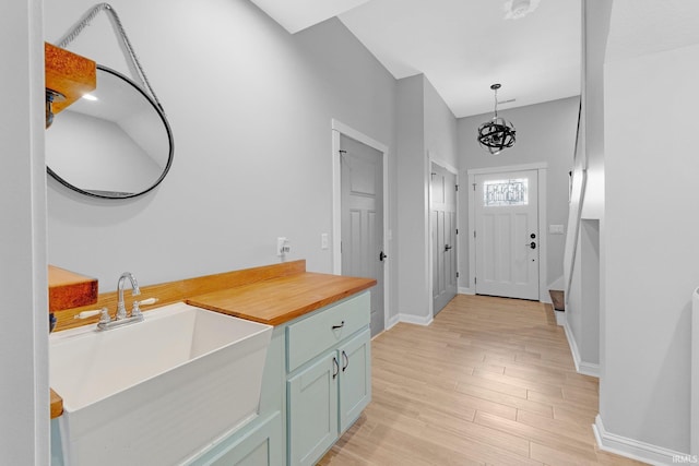 foyer entrance with light wood-style flooring and baseboards