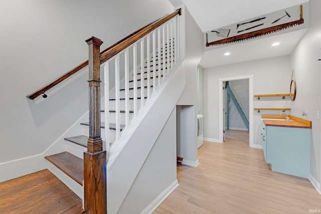 staircase with recessed lighting, baseboards, and wood finished floors