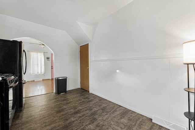 bonus room with wood finished floors, visible vents, arched walkways, and lofted ceiling