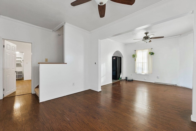 unfurnished living room with wood finished floors, baseboards, arched walkways, ceiling fan, and ornamental molding