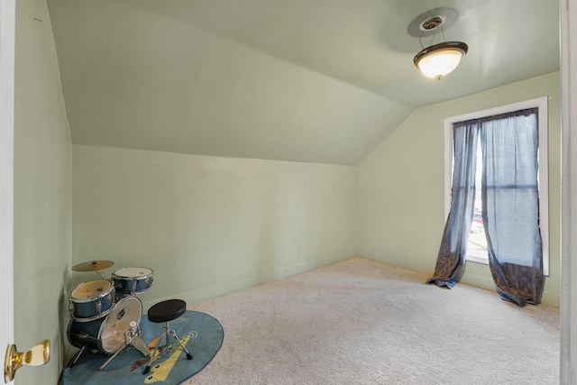 bonus room with lofted ceiling and carpet floors