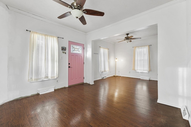 foyer entrance with visible vents, hardwood / wood-style floors, and crown molding