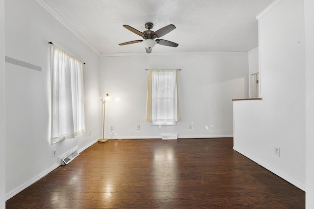 empty room featuring visible vents, crown molding, and wood finished floors