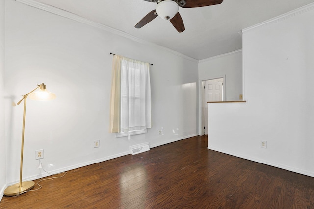 unfurnished room with visible vents, baseboards, wood finished floors, and crown molding