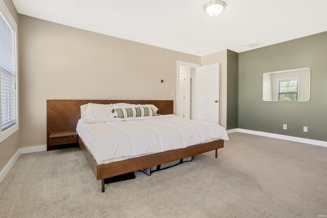 carpeted bedroom with visible vents and baseboards