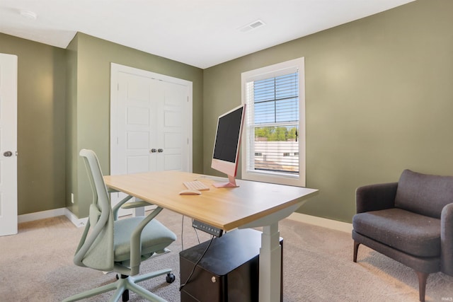 carpeted office space with visible vents and baseboards