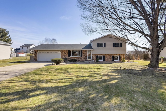 tri-level home featuring a front yard, fence, concrete driveway, a garage, and brick siding