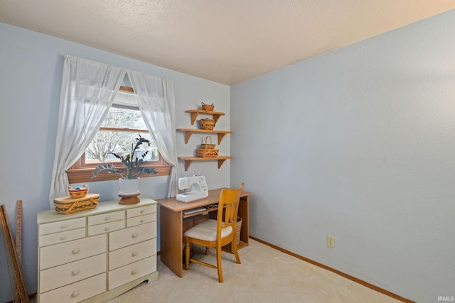 home office featuring light colored carpet and baseboards