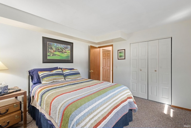 carpeted bedroom with baseboards and a closet