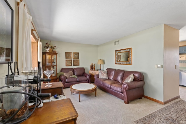 living area featuring light carpet, visible vents, and baseboards