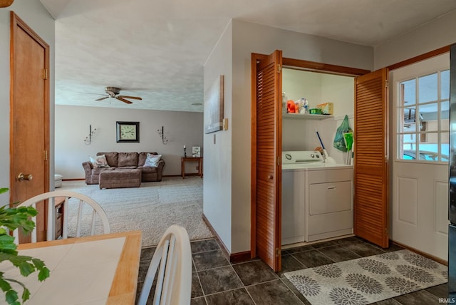 laundry room featuring washer and clothes dryer, dark colored carpet, baseboards, ceiling fan, and laundry area